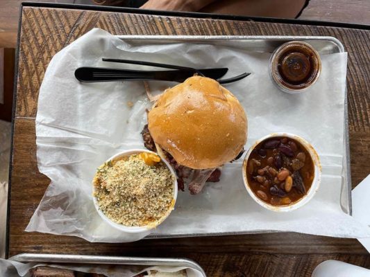 Deviled Pig pork sandwich with sides